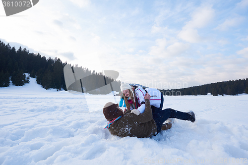 Image of happy family playing together in snow at winter