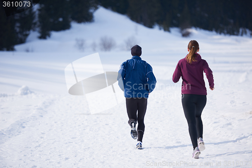 Image of couple jogging outside on snow