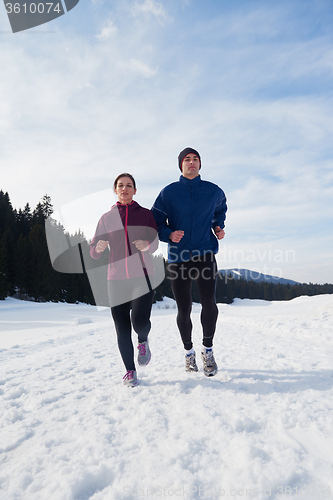 Image of couple jogging outside on snow