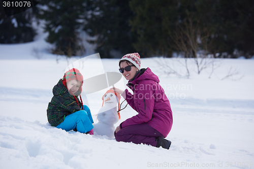 Image of happy family building snowman