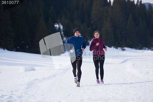 Image of couple jogging outside on snow