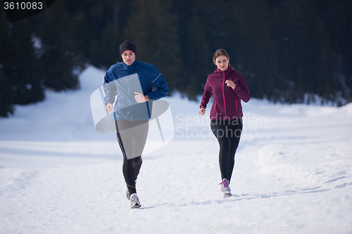 Image of couple jogging outside on snow