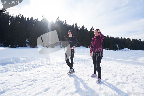 Image of couple jogging outside on snow