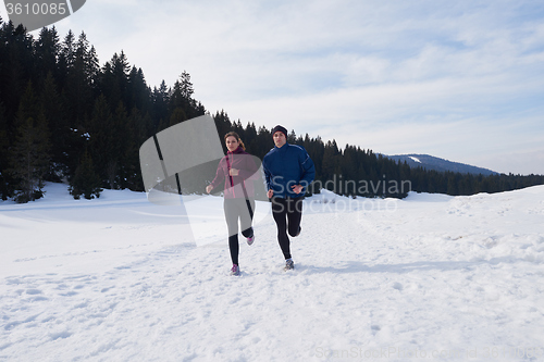 Image of couple jogging outside on snow