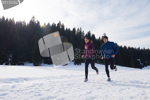 Image of couple jogging outside on snow