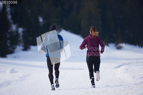 Image of couple jogging outside on snow