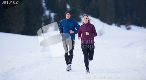 Image of couple jogging outside on snow