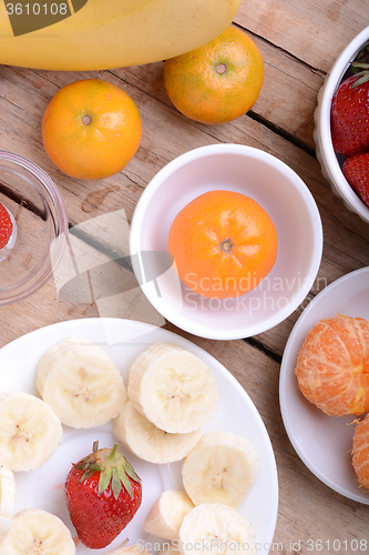 Image of Fresh colorful fruits composition mandarin, strawberry, peach, bananas and orange