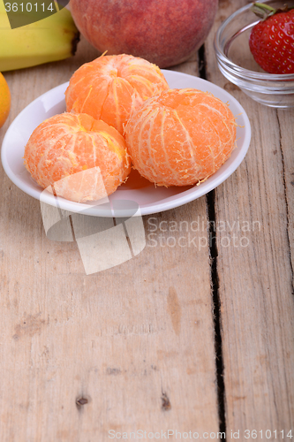 Image of Fresh colorful fruits composition mandarin, strawberry, peach, bananas and orange