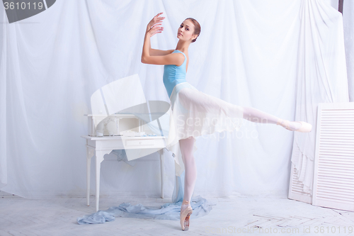 Image of Professional ballet dancer posing on white