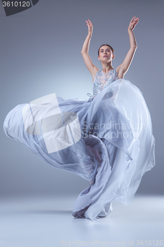 Image of The beautiful ballerina dancing in blue long dress 