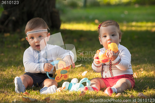 Image of Babys, less than a year old, playing with  toys 