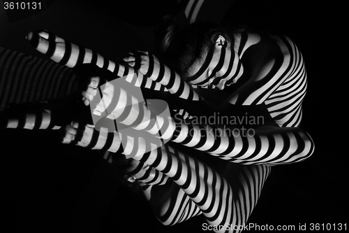 Image of The nude woman with black and white zebra stripes