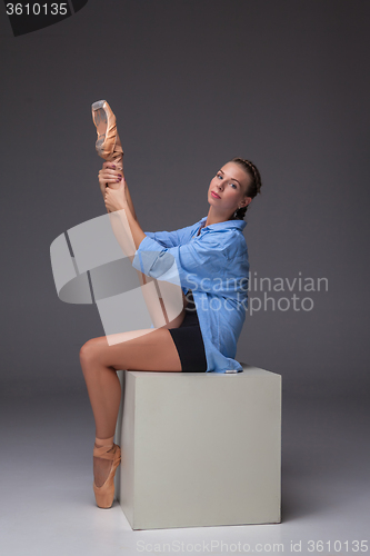 Image of Young beautiful modern style dancer posing on a studio background