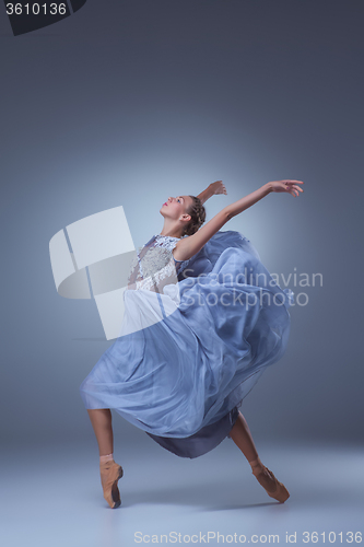 Image of The beautiful ballerina dancing in blue long dress 