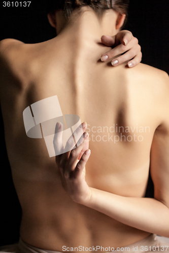 Image of Beautiful woman, back view on dack background