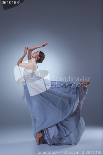 Image of The beautiful ballerina dancing in blue long dress 