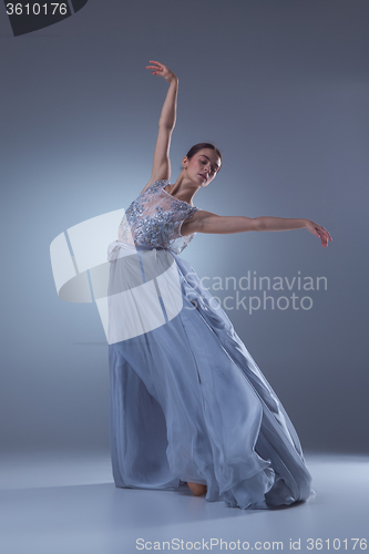 Image of The beautiful ballerina dancing in blue long dress 