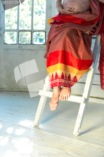 Image of Legs decorated with indian mehandi painted henna 