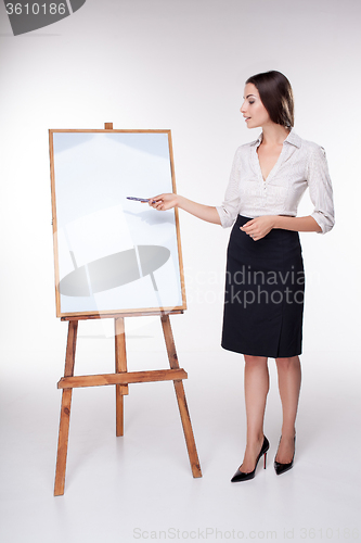 Image of young business woman showing something on the white background