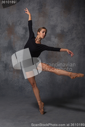 Image of Young beautiful modern style dancer posing on a studio background