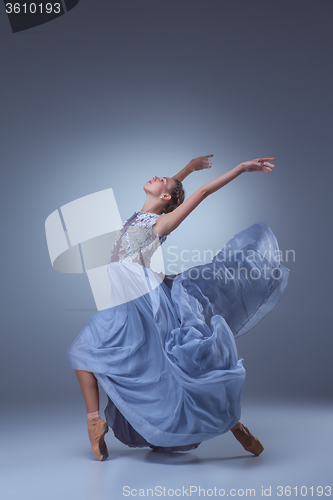 Image of The beautiful ballerina dancing in blue long dress 