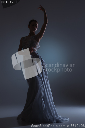 Image of The beautiful ballerina dancing in blue long dress 