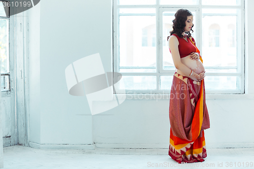 Image of The pregnant woman belly with henna tattoo