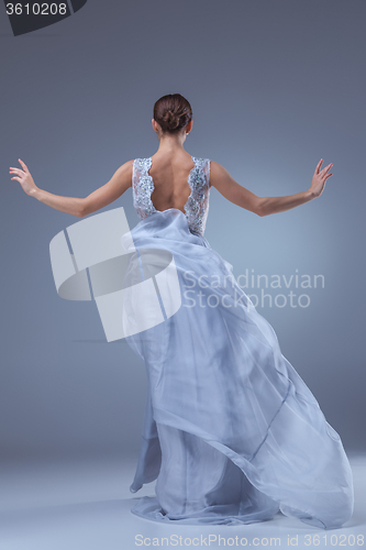 Image of The beautiful ballerina dancing in blue long dress 