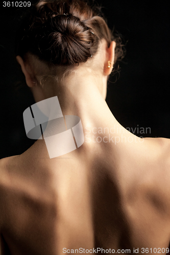 Image of Beautiful woman, back view on dack background