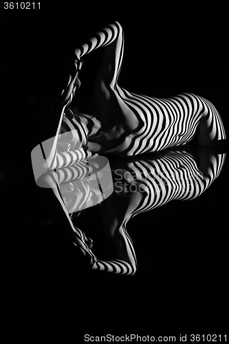 Image of The nude woman with black and white zebra stripes