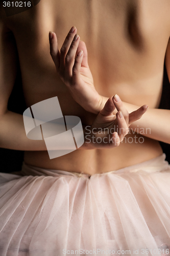 Image of Beautiful ballerina, back view on dack background