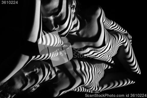 Image of The nude woman with black and white zebra stripes