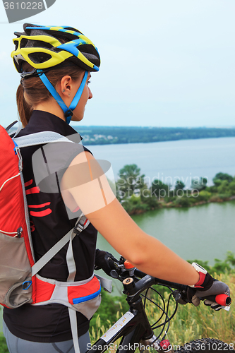 Image of Young girl riding bicycle outside. Healthy Lifestyle.