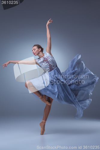 Image of The beautiful ballerina dancing in blue long dress 