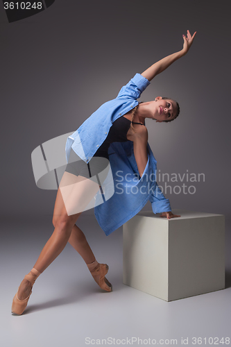 Image of Young beautiful modern style dancer posing on a studio background