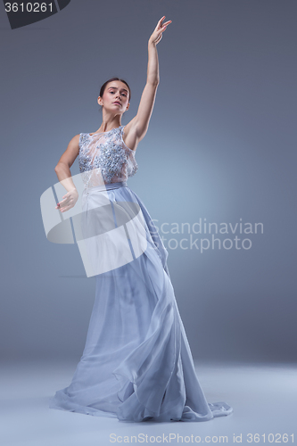 Image of The beautiful ballerina dancing in blue long dress 