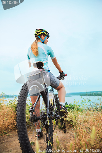 Image of Young girl riding bicycle outside. Healthy Lifestyle.