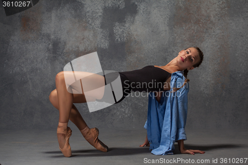 Image of Young beautiful modern style dancer posing on a studio background