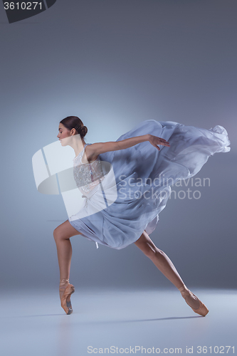 Image of The beautiful ballerina dancing in blue long dress 