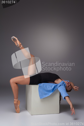 Image of Young beautiful modern style dancer posing on a studio background