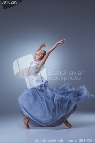 Image of The beautiful ballerina dancing in blue long dress 