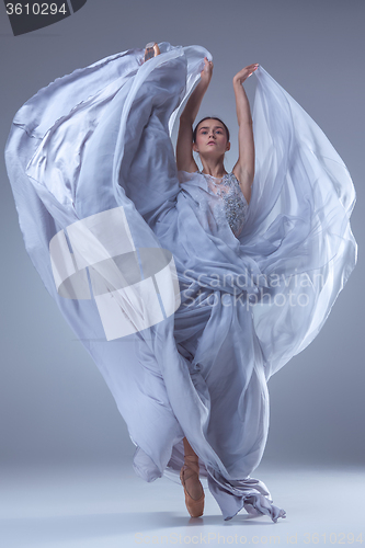 Image of The beautiful ballerina dancing in blue long dress 