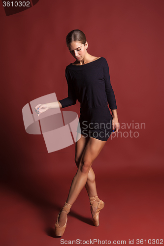Image of Young beautiful modern style dancer posing on a studio background