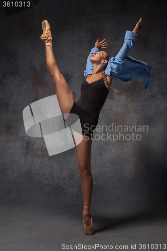 Image of Young beautiful modern style dancer posing on a studio background