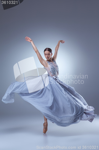 Image of The beautiful ballerina dancing in blue long dress 