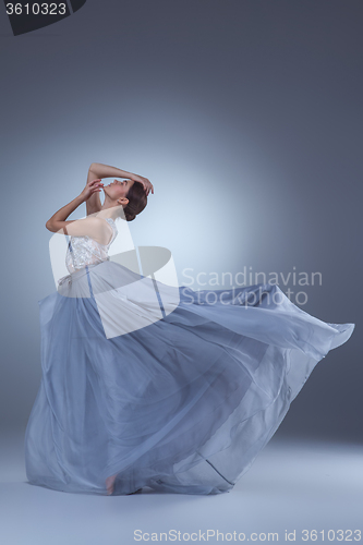 Image of The beautiful ballerina dancing in blue long dress 