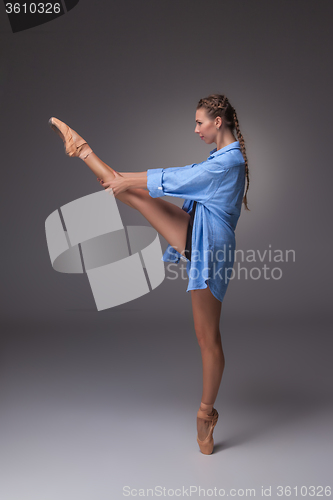 Image of Young beautiful modern style dancer posing on a studio background