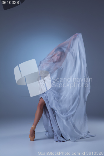 Image of The beautiful ballerina dancing in blue long dress 