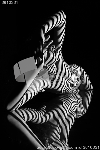 Image of The nude woman with black and white zebra stripes